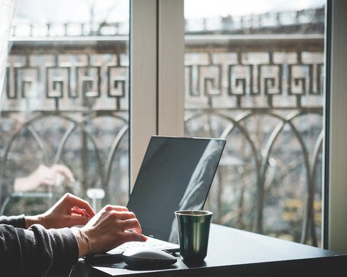 Person working on laptop in a sunlit room in Chile