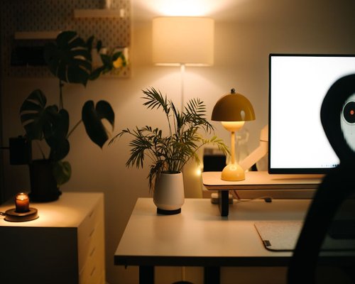 Cozy desk setup with warm desk lamp lighting